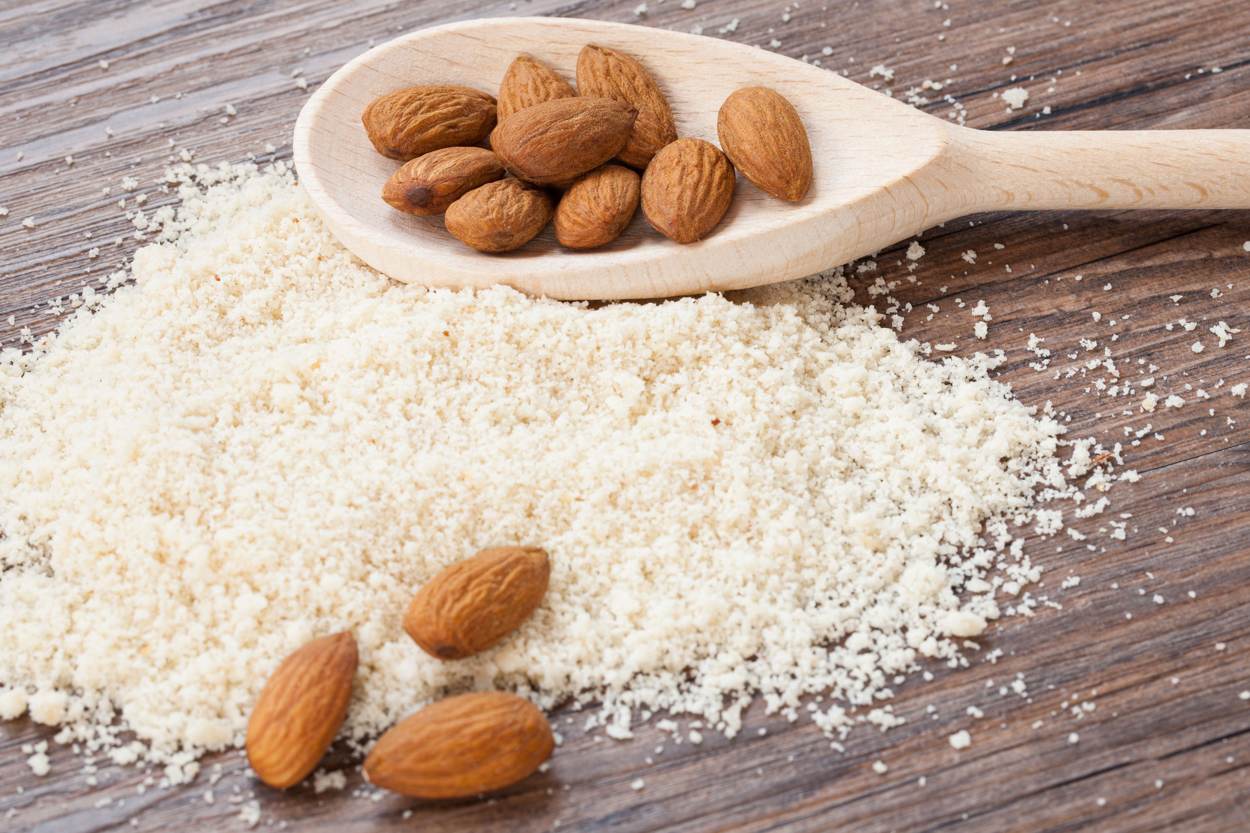 31820730 - almond flour, almonds in a dark wood background